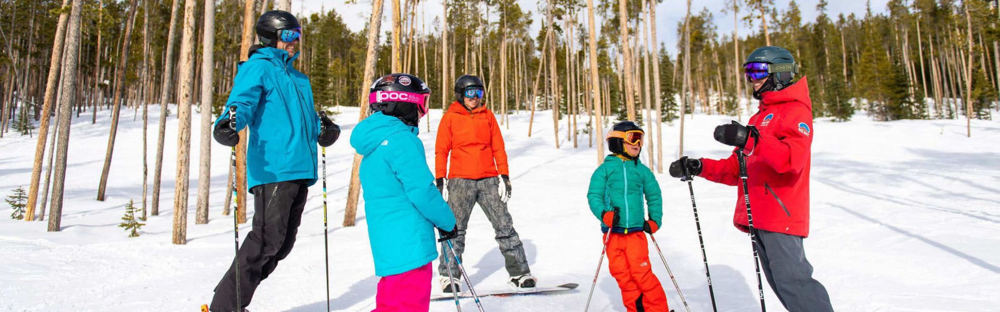 Family skiing with a ski instructor